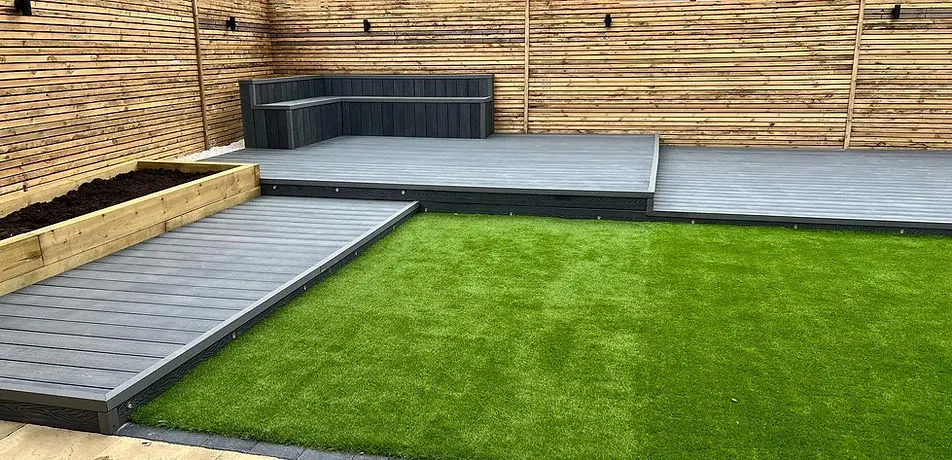 Raised composite decking with an artificial grass lawn installed by JDS Landscaping