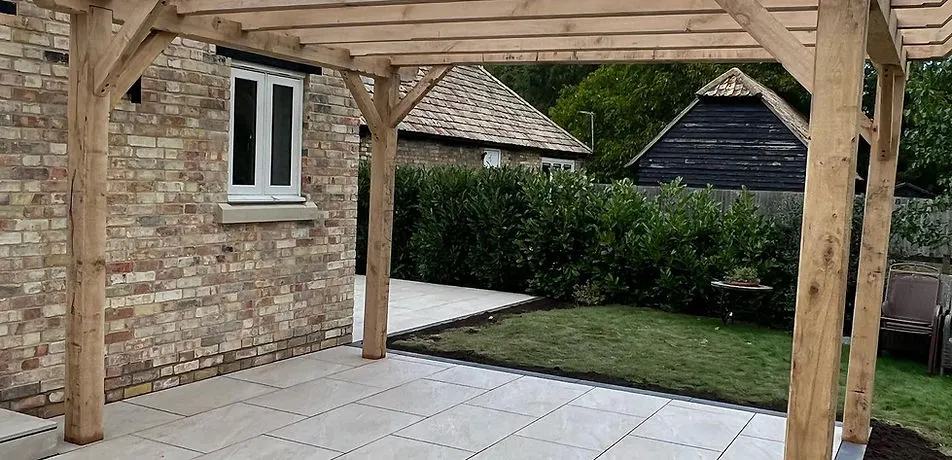 Timber pergola over a porcelain patio beside a new lawn, built by JDS Landscaping